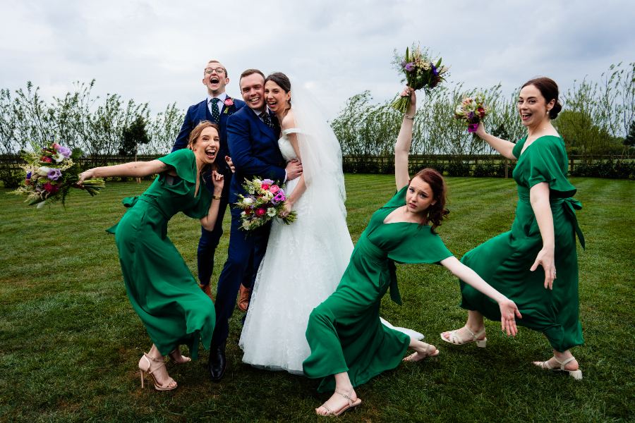 Bridesmaids in green striking silly poses