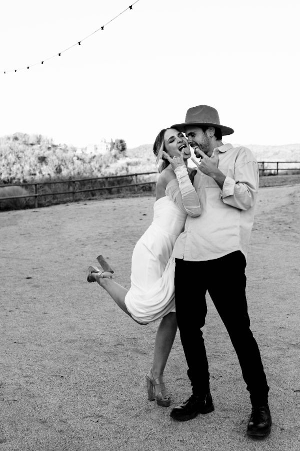 Couple pulling rock horns and tongues out