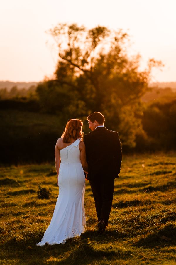 Couple walking into a golden sunset